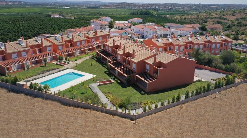 House 2 bedrooms Semidetached townhouse Alcantarilha Silves - store room, balcony, automatic gate, barbecue, fireplace, double glazing, solar panels, gated community, equipped, terrace, garden, garage, swimming pool
