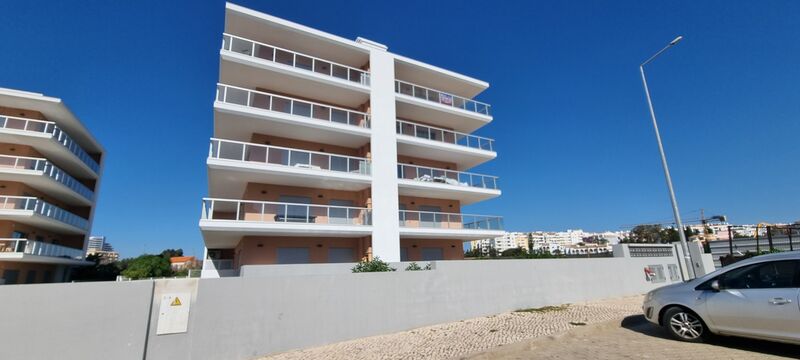 Apartamento T1+1 novo com vista mar Praia da Rocha Portimão - cozinha equipada, ar condicionado, jardim, piscina, chão radiante, varanda, vista mar, bbq, condomínio fechado